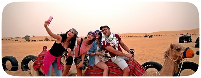 Group taking selfie on camel